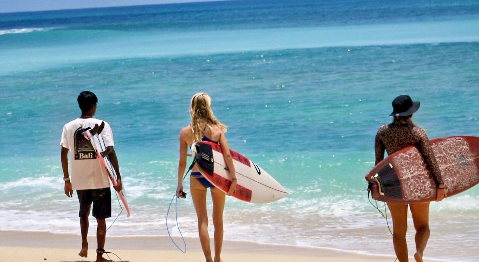 Surf trip group with their boards on the beach