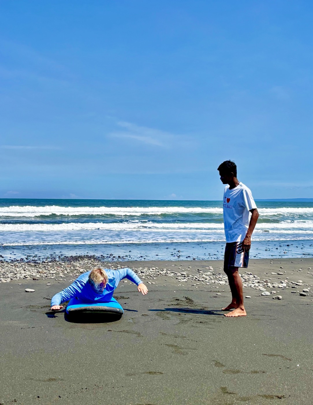 Beach briefing before a beginner surf lesson in Medewi