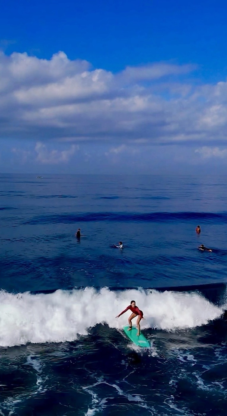 Beginner catching a first wave in Medewi
