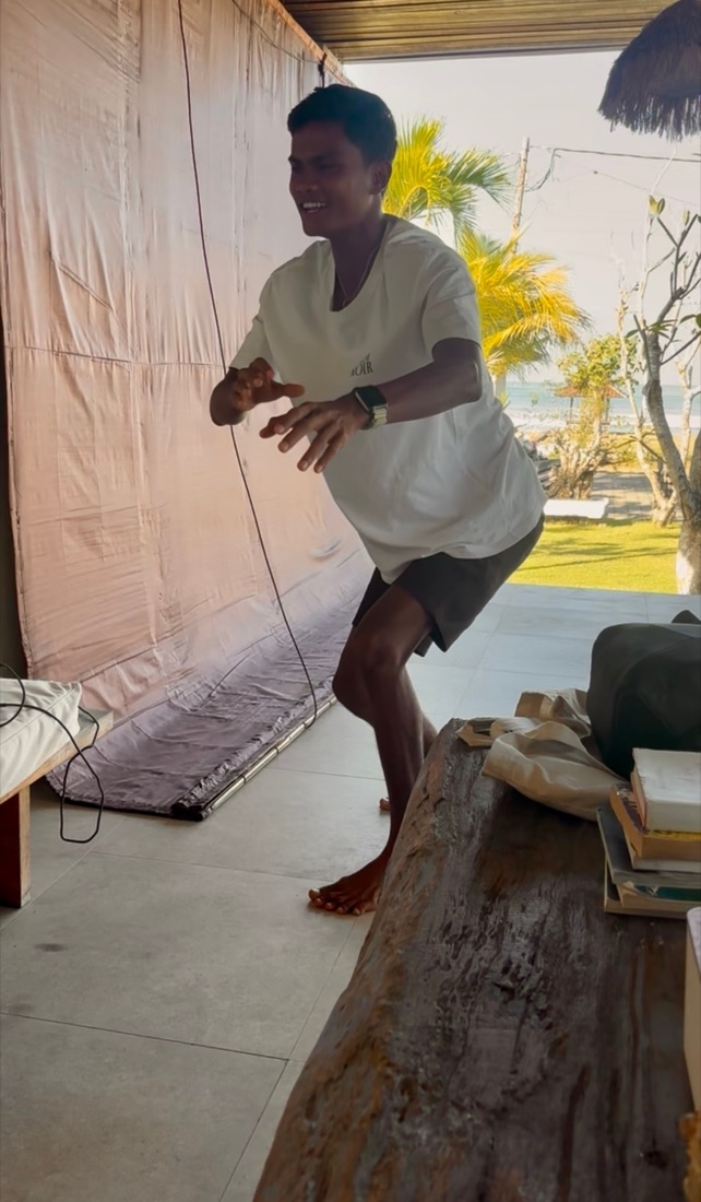 Surf coach demonstrating the pop-up on dry land during a video analysis session