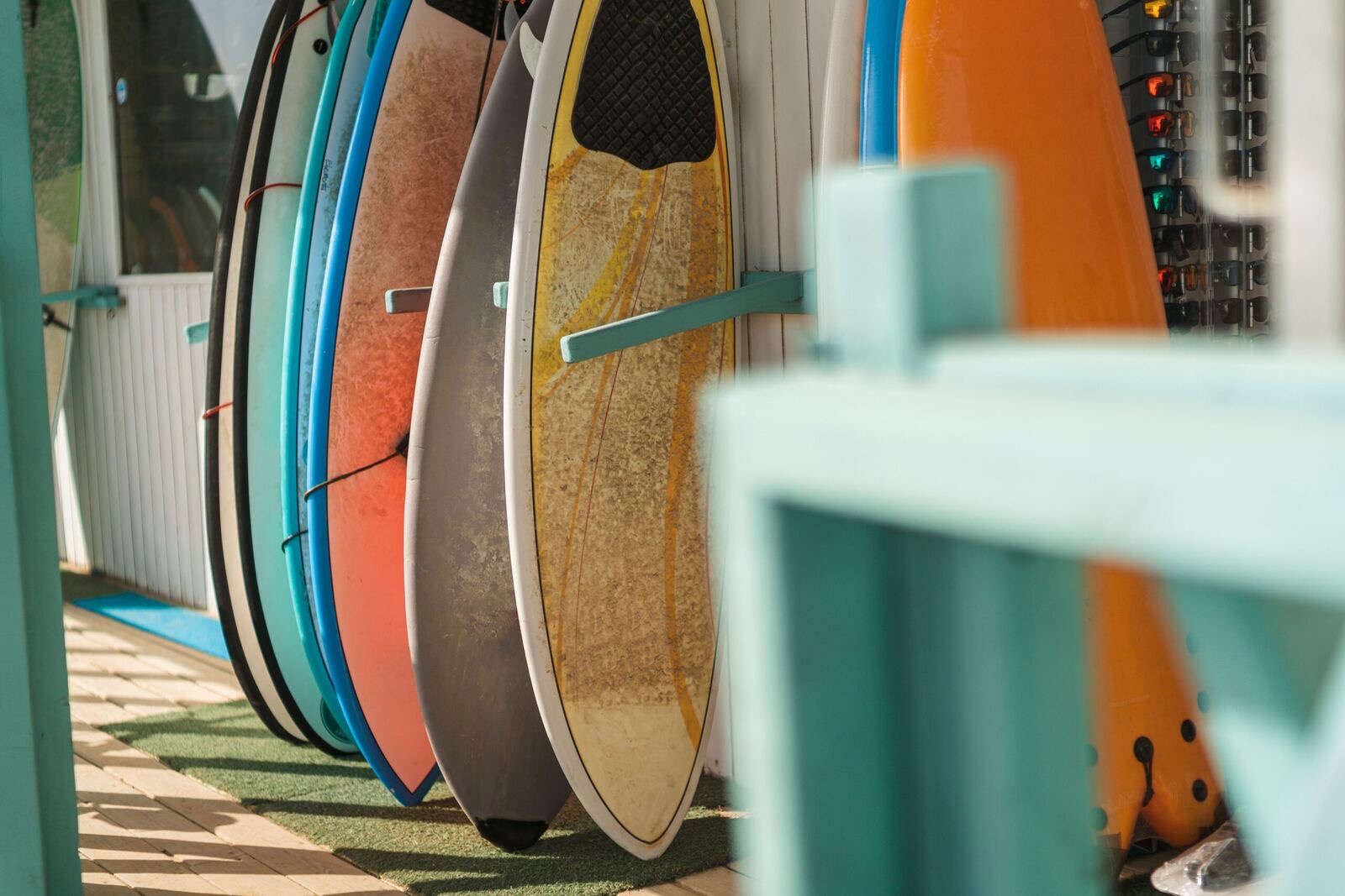 Surfboards lined up in a rack, ready for the morning session